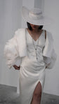 Petal-sleeve bridal jacket over a V-neck slit slip dress and long beaded necklace, hat brim shading the face, My Darling Hurricane