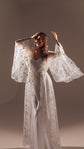 Model with arms raised in a long star tulle bridal robe over a white slip dress, soft studio light, Orion Robe