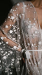Close-up of glitter tulle and stars on a bridal robe sleeve with a satin ribbon tie, Orion Robe