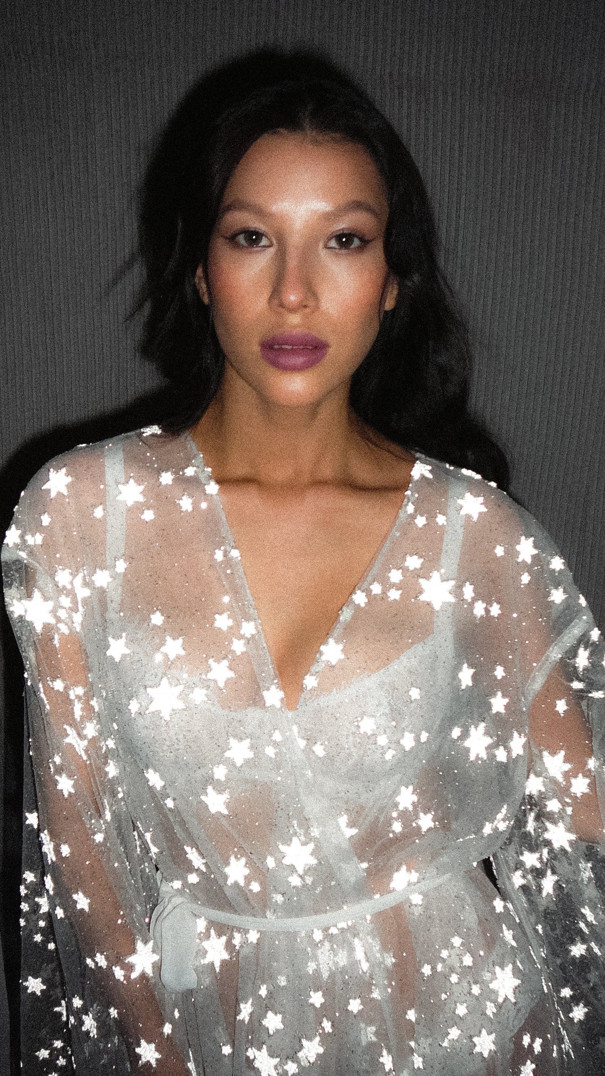Close-up portrait in a V-neck star bridal robe of sheer tulle, every star bright in the flash, Orion Robe