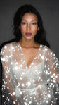 Close-up portrait in a V-neck star bridal robe of sheer tulle, every star bright in the flash, Orion Robe