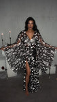 Black celestial bridal robe with wide bell sleeves and stars flashing white, high slit, candles behind, Orion Robe Black by Ephemeris