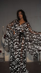 Model with arms held out in a black star bridal robe tied with a black ribbon, sleeves spread wide, Orion Robe Black