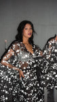 Waist-up shot in a black star tulle bridal robe, hand on hip and one sleeve fanned out, Orion Robe Black