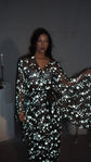 Moody flash shot of a black star bridal robe with bell sleeves spread, model standing in a dark room, Orion Robe Black