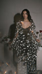 Soft-focus shot of an open black star bridal robe over a black slip, light flare in the foreground, Orion Robe Black