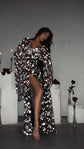 Model leaning against a white plinth in a black starry bridal robe with long bell sleeves, Orion Robe Black