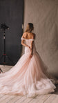 Blush wedding dress with off-shoulder draped tulle and a fit and flare skirt, back view in a studio, Peony by Ephemeris