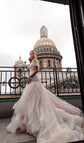 Bride on a rooftop terrace in a blush fit and flare wedding dress, domed cathedral behind, Peony