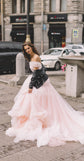 Bride twirling a blush tulle wedding dress with a black leather jacket off the shoulders, city street, Peony