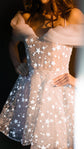 Torso crop of a star lace mini wedding dress, organza off-shoulder drapes and flared skirt in warm light, Shooting Star