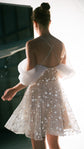 Back view of a star lace mini wedding dress with crossed straps and off-shoulder drapes, bright studio, Shooting Star
