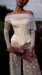 Satin bridal corset layered under a sheer off-shoulder long-sleeve top, star lace trousers and a lupin bouquet, Solana Corset