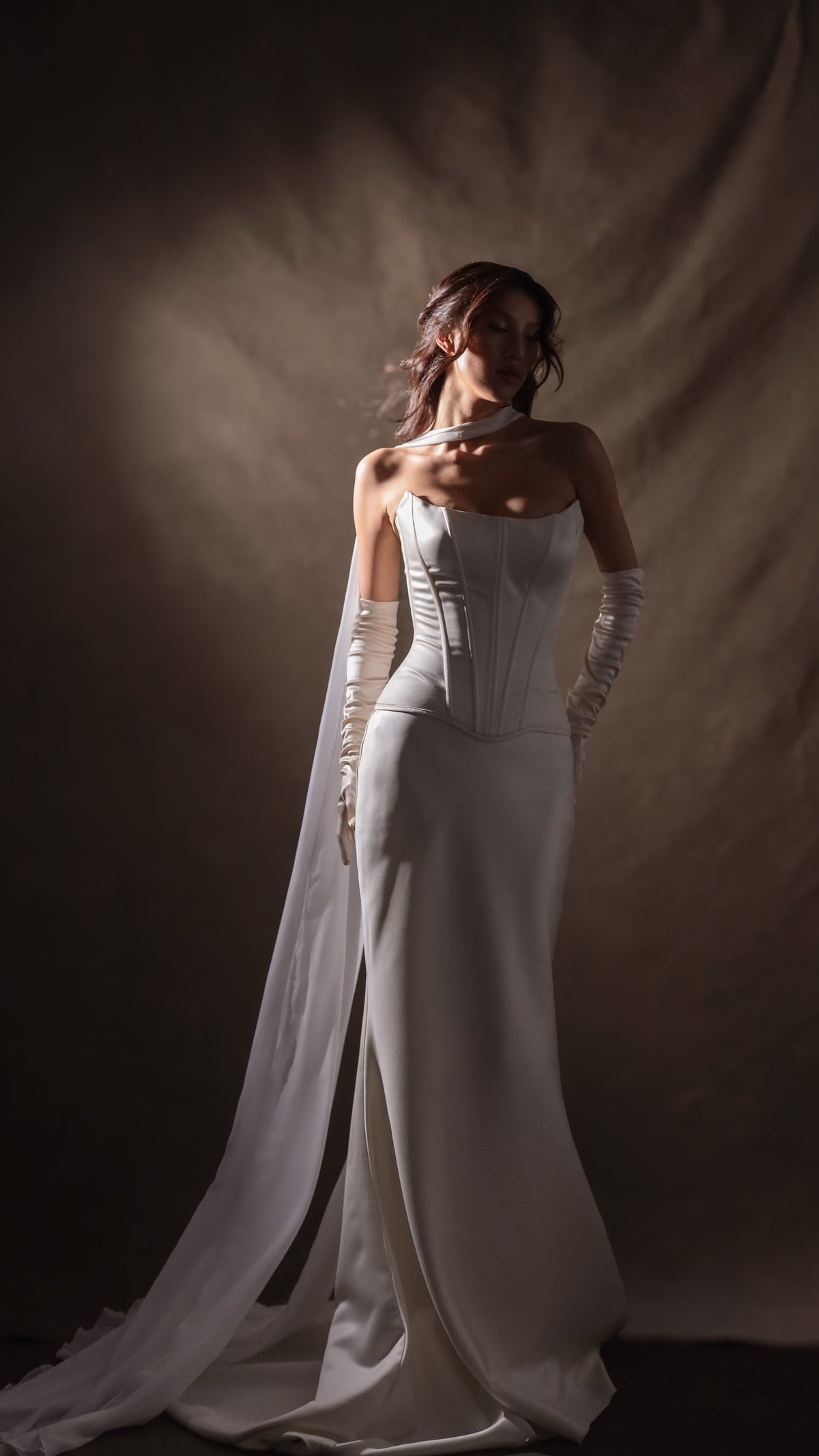 Full-length satin bridal separates in a pool of studio light, scarf streaming to a satin train, gloves to the elbow, Solana Ensemble