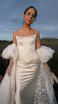 Front portrait in a satin bridal skirt and Solana Corset, puffed sleeves and a star tulle overskirt, open sky, Solana Skirt