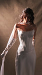 Satin bridal skirt with the Solana Corset, bride looking down with a chiffon scarf over one gloved arm, side light, Solana Skirt