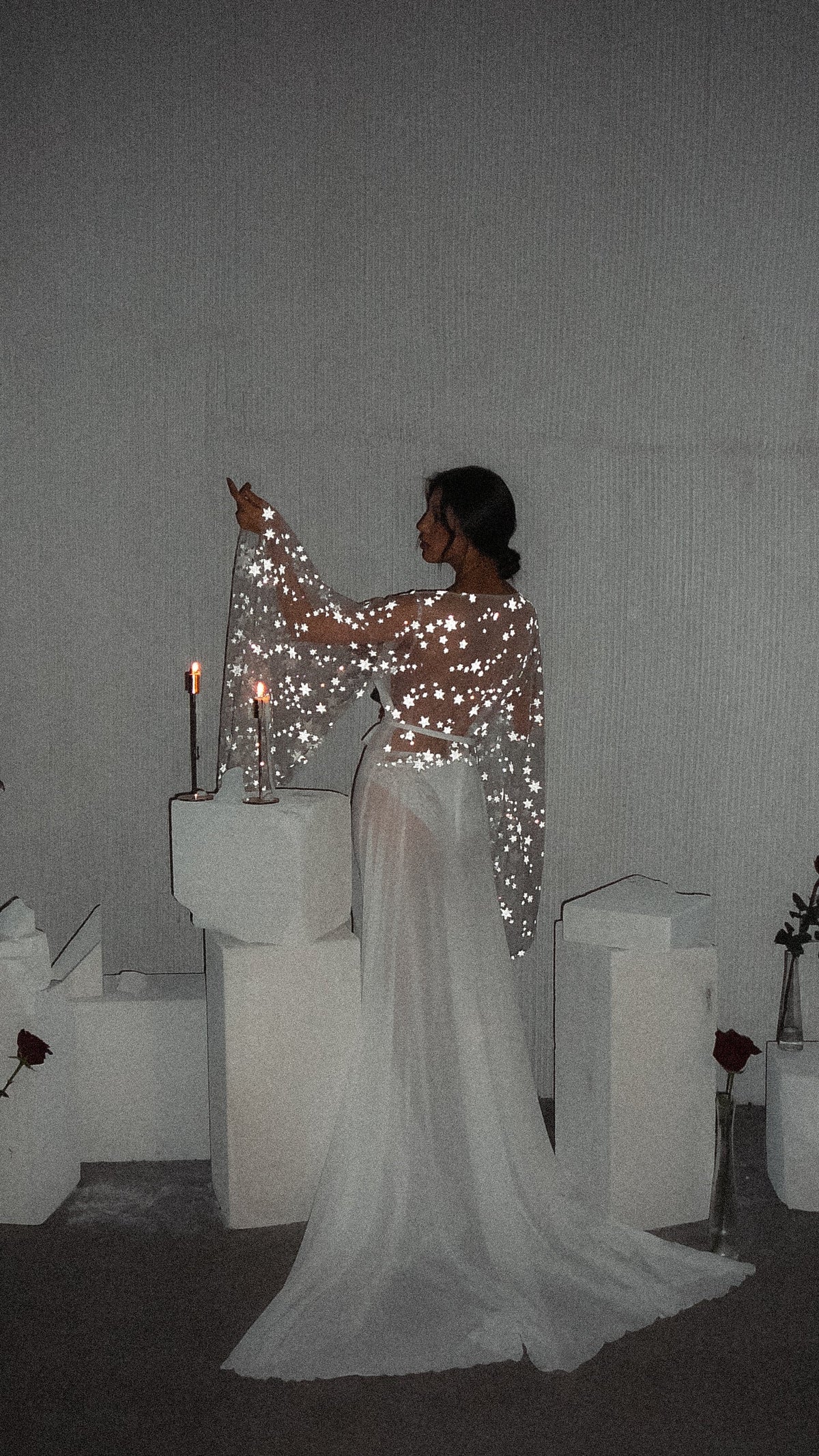 Back view of a bridal robe with star lace across the back and an arm raised in a wide sleeve, chiffon train behind, Stargazer Robe Ivory