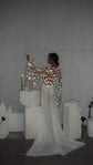Back view of a bridal robe with star lace across the back and an arm raised in a wide sleeve, chiffon train behind, Stargazer Robe Ivory