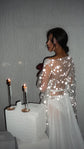 Over-the-shoulder view of a sheer chiffon bridal robe, star lace on the back catching the flash beside lit candles, Stargazer Robe Ivory