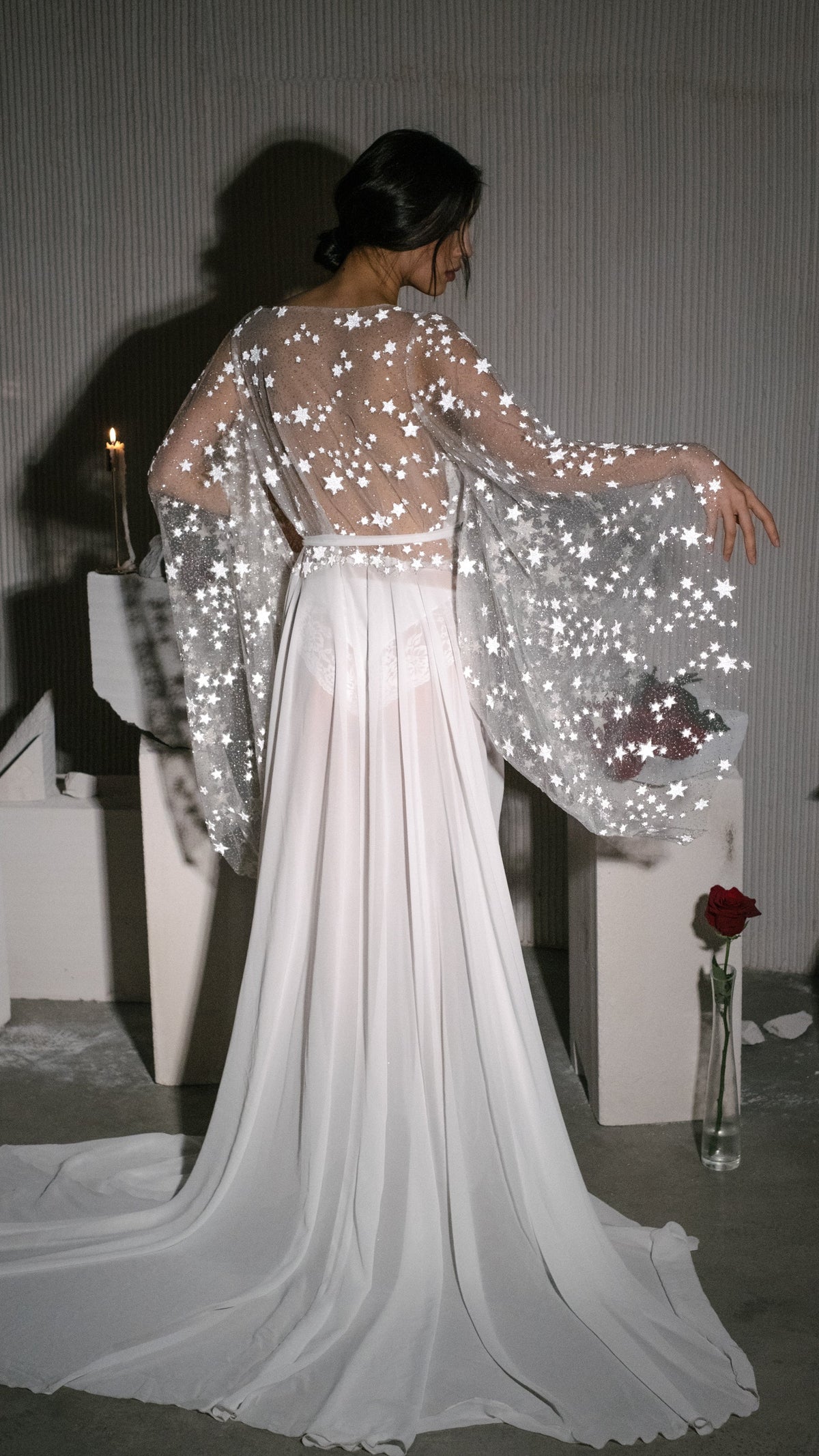 Back view of a bridal robe with arms out, wide star lace sleeves and a long chiffon train in studio light, editorial, Stargazer Robe Ivory