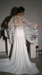 Back view of a bridal robe with arms out, wide star lace sleeves and a long chiffon train in studio light, editorial, Stargazer Robe Ivory