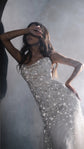 Model leaning back with an arm over her eyes in a fitted star wedding dress with fine straps, hazy arch, editorial, Supernova