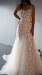 Front view of a fitted star wedding dress with spaghetti straps and tulle godets flaring to the floor, studio, Supernova