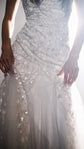 Close crop of the fitted bodice of a star wedding dress with reflective glass beads and tulle insets at the hips, Supernova