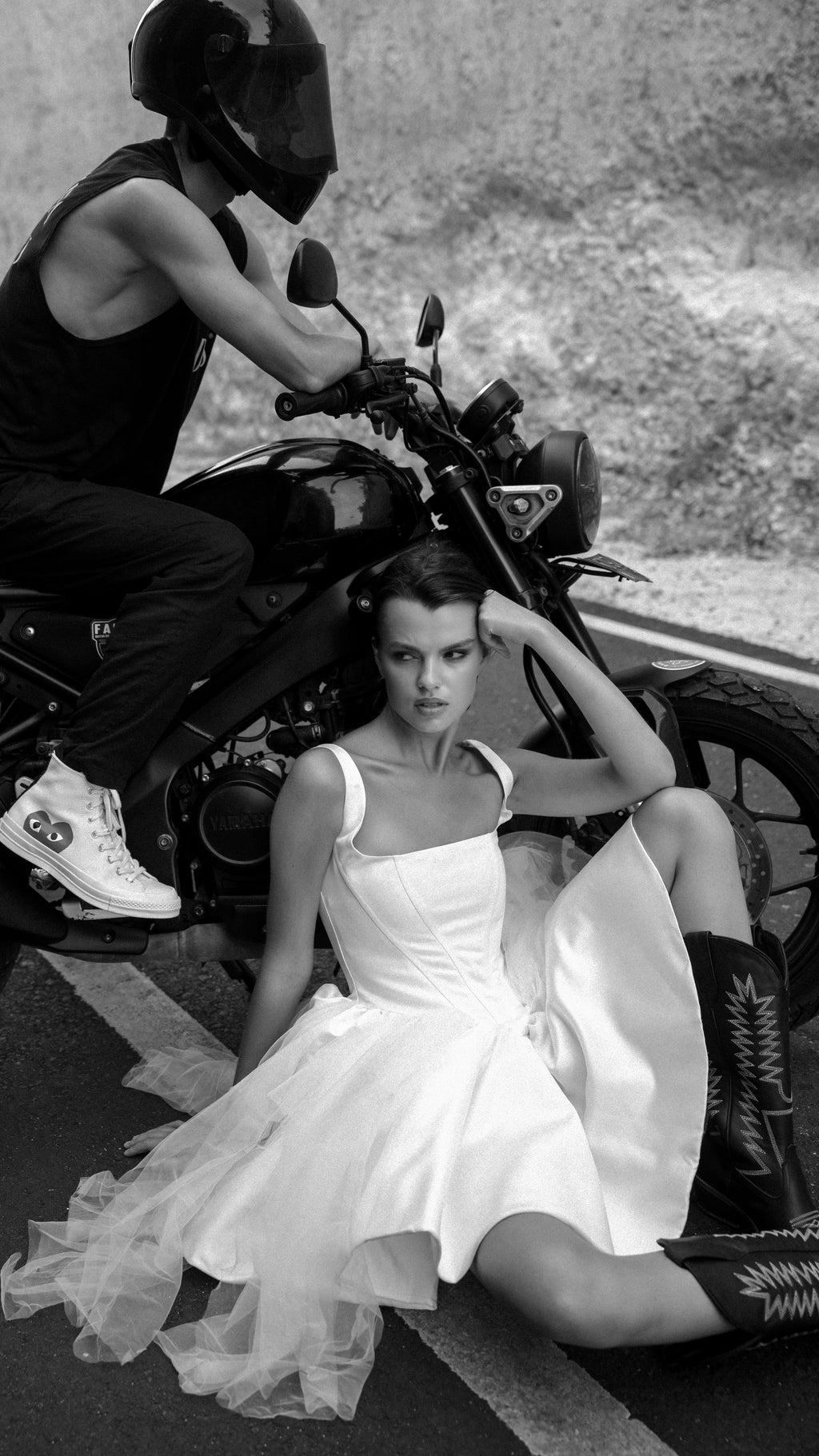 Satin corset mini wedding dress with a square neck and tulle skirt, bride in cowboy boots by a motorbike, black and white, Swan by Ephemeris