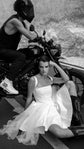 Satin corset mini wedding dress with a square neck and tulle skirt, bride in cowboy boots by a motorbike, black and white, Swan by Ephemeris