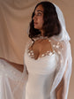 Profile of a bride in a hooded star cape over the satin corset of a bridal separates set, studio drape, Venus Ensemble