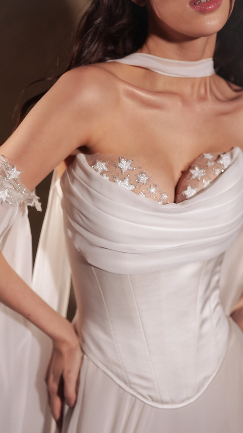 Close crop where an A-line chiffon bridal skirt meets the Venus Corset with a basque waist, star lace cuff on a sheer sleeve, Venus Skirt