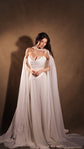 Bride looking down in a floor-length chiffon bridal skirt with the train spread out, sheer sleeves pooling beside it, Venus Skirt