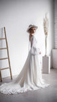 Side view of a bride by a ladder in a long-sleeve chiffon wedding dress, the train swirling across the concrete floor, When the Moon is Out