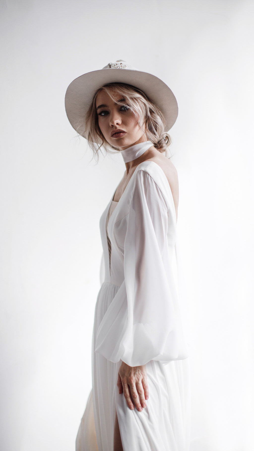 Bride in profile with a chiffon scarf at the neck, sheer balloon sleeve of an A-line wedding dress, bright window light, When the Moon is Out