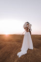 Back view of a couple kissing on a hilltop at sunset, chiffon wedding dress with the back scarf and long train, When the Moon is Out