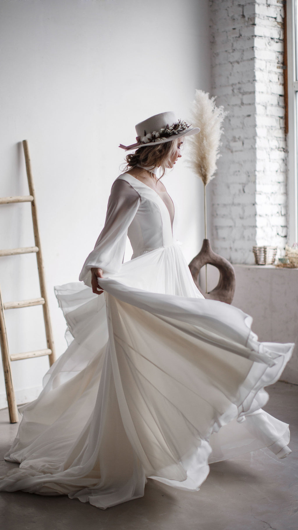 Bride spinning in a chiffon A-line wedding dress with a plunging neckline, skirt fanning out by pampas grass, When the Moon is Out