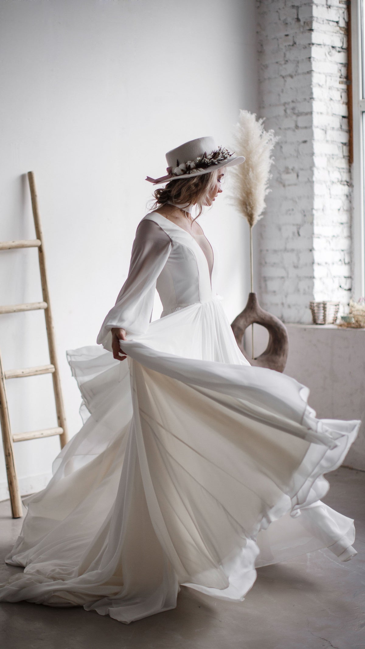 Bride spinning in a chiffon A-line wedding dress with a plunging neckline, skirt fanning out by pampas grass, When the Moon is Out