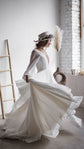 Bride spinning in a chiffon A-line wedding dress with a plunging neckline, skirt fanning out by pampas grass, When the Moon is Out