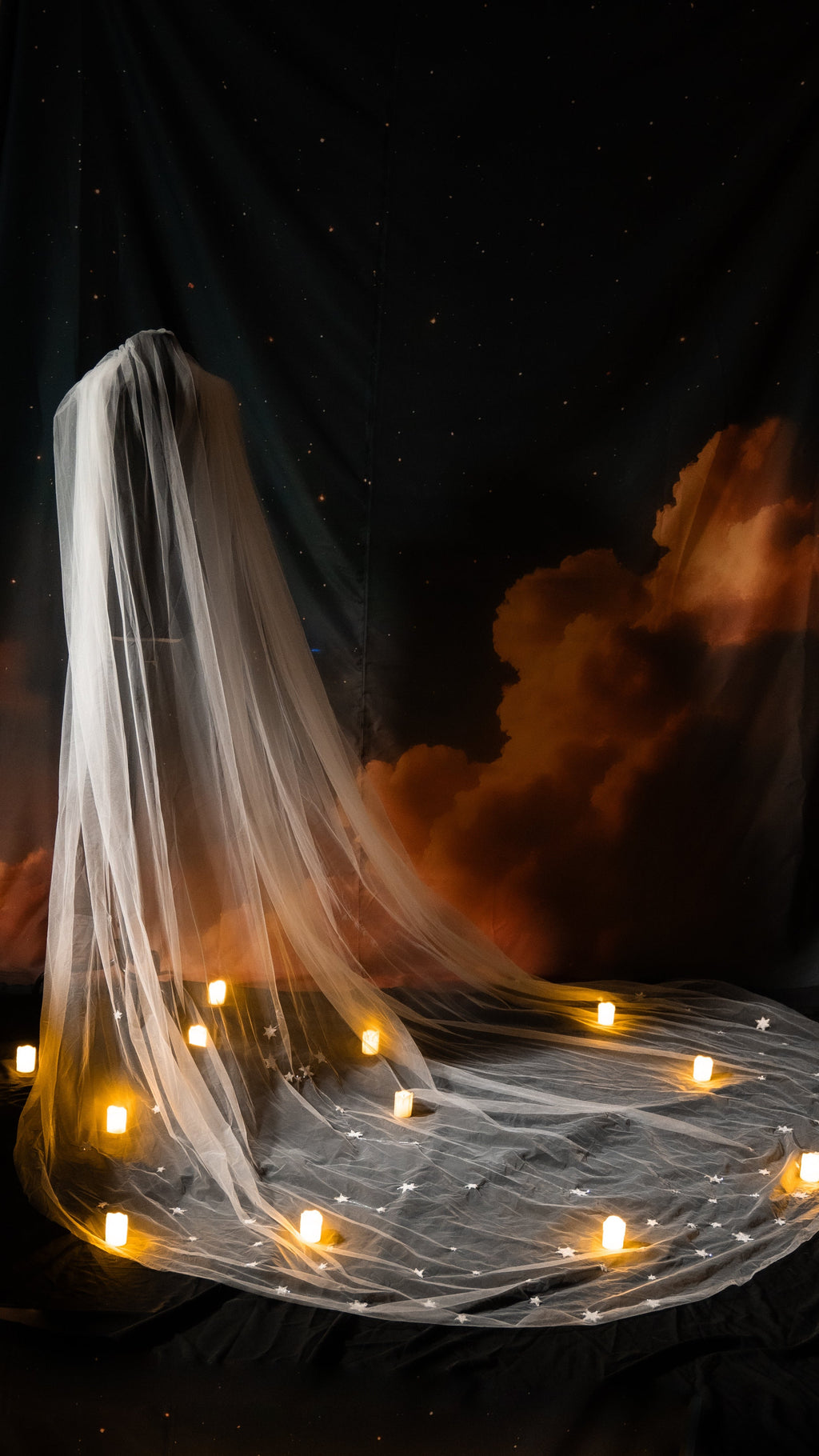 Cathedral wedding veil with custom star sign constellations on soft ivory tulle, draped over a stand among candles, Zodiac Veil by Ephemeris