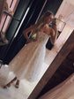 Mirror selfie in a shop of a spaghetti strap star wedding dress with a midi tulle skirt and glitter sandals, Wild Stars
