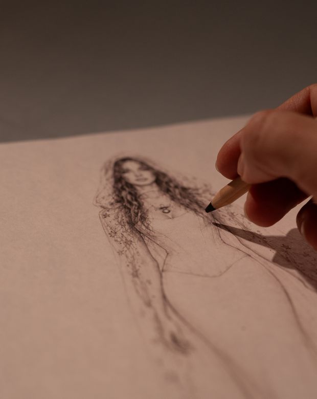 A bridal design being sketched by hand